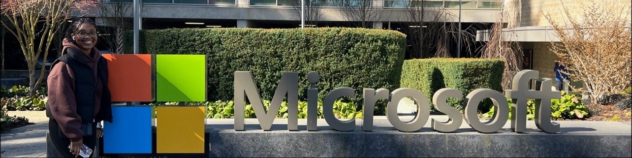 Gabrielle Williams next to the Microsoft logo sign outside a building on the Microsoft campus